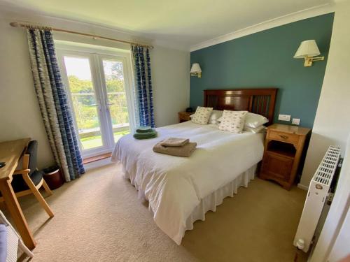 a bedroom with a large bed and a window at Millbrook in Penistone