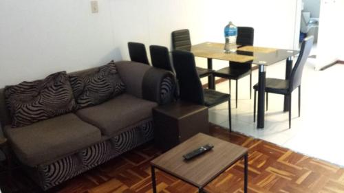 a living room with a couch and a table at Rosebank Accommodation in Johannesburg