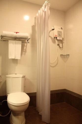 a bathroom with a toilet and a shower at Kuiburi Hotel & Resort in Kui Buri