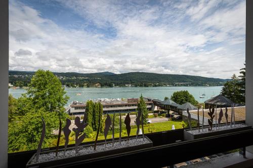 a balcony with a view of a body of water at Hotel Parks in Velden am Wörthersee