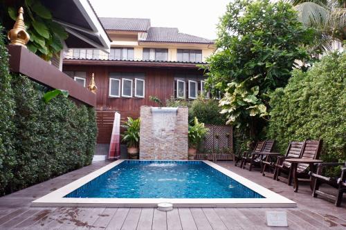 una piscina en el patio trasero de una casa en i Lanna House en Chiang Mai