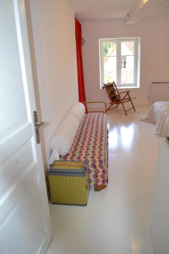 a living room with a couch and a chair at Chambre privative et originale, à 20 mn de Cluny in Trivy