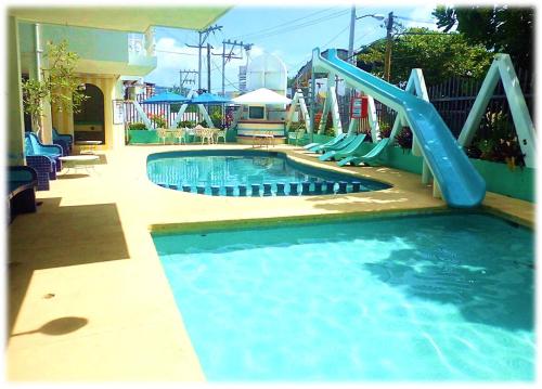 a swimming pool with a slide in a playground at Suites Angelopolis in Acapulco