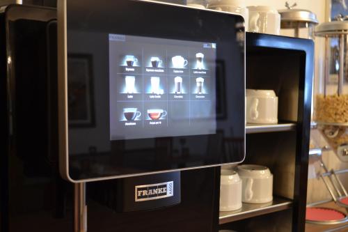 a vending machine with a screen on a shelf at Albergo Majorka in Canazei