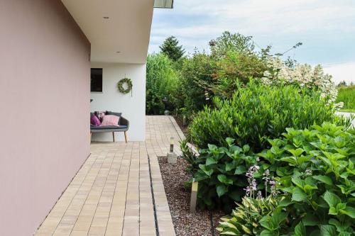 a patio with a couch and some plants at Moderne Ferienwohnung Nähe Bad Griesbach, Haarbach in Haarbach