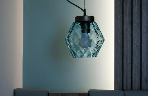 a glass vase hanging from a wall at Aqua Boutique Hotel in Castiglione della Pescaia