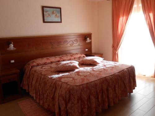 a bedroom with a bed with two pillows on it at Affittacamere Les Noyers in Verrayes