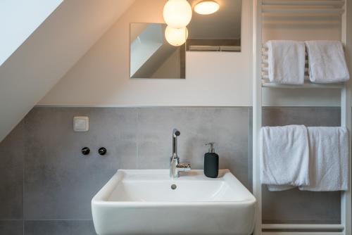 a bathroom with a white sink and a staircase at CASSEL LOFTS - Stilvolles Loft im Grünen mit Balkon nahe VW-Werk in Kassel