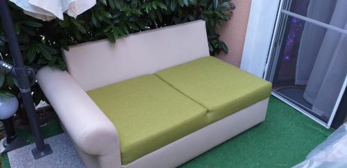 a white and green bench sitting next to a window at Aphrodite Rose in Sunny Beach