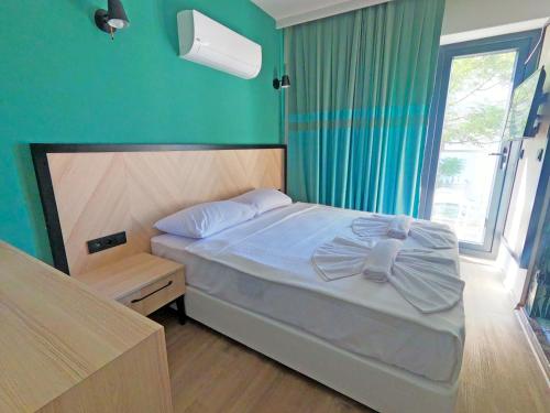 a bedroom with a bed and a green wall at Yeshill Boutique Hotel in Marmaris