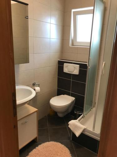 a small bathroom with a toilet and a sink at Apartments Grozdana in Gradac