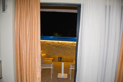 a room with a table and chairs and a window at AM Palace in Ulcinj