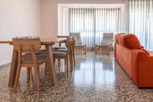 comedor con mesa, sillas y sofá en Apartamento Sambala, en Ontinyent