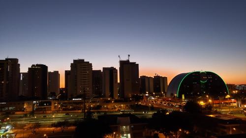 a city skyline at night with a lot of buildings at Garvey Flats in Brasilia
