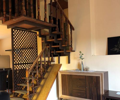 a spiral staircase in a room with a wooden cabinet at APARTMAN 4. in Balatonalmádi