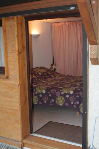 a small bedroom with a bed and a window at Studio "Le Plan du Crêt" in Mercury