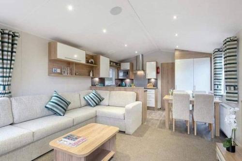 a living room with a couch and a table at Premium Chalet at Newquay Away Resorts MV7 in Newquay