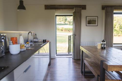 a kitchen with a wooden counter top and a table at Hayloft in Cheddar