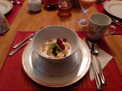 a bowl of cereal with fruit and vegetables on a table at Gîte À l'Augustine in Quebec City