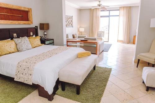 a bedroom with a large bed and a living room at Fishing Lodge Cap Cana in Punta Cana
