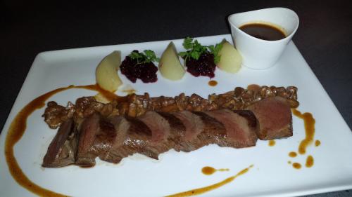 a plate of food with meat and fruit and a cup of coffee at Landhaus Hohly in Löwenstein