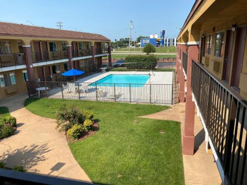 an apartment courtyard with a swimming pool in a building at Super 8 by Wyndham Midwest City OK in Midwest City