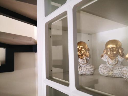 two masks sitting on a shelf in a room at Затишні апартаменти, Дерибасівська in Odesa