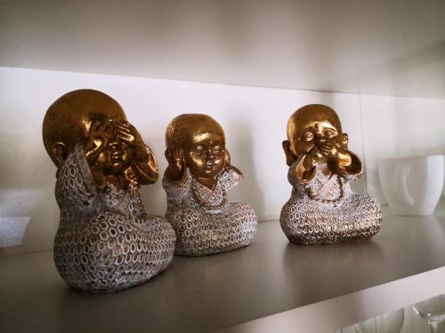 three bronze head statues sitting on a table at Затишні апартаменти, Дерибасівська in Odesa