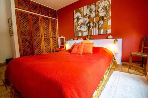 a red bedroom with a large red bed at Idyllic Farm House Amazing Landscap Sea View in Loulé