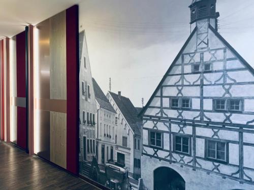 a window with a picture of a building at Stadthotel Kachelofen in Krumbach
