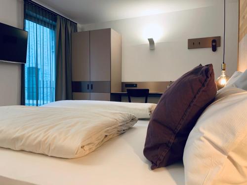 a bedroom with a large bed with a large window at Stadthotel Kachelofen in Krumbach
