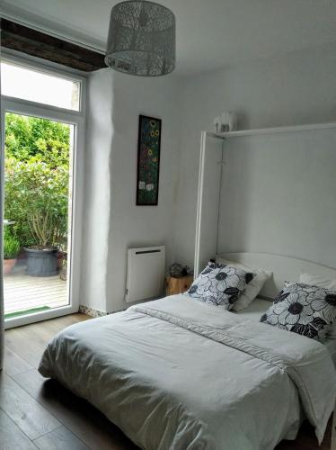 une chambre avec un lit et une grande fenêtre dans l'établissement grande terrasse arborée, à Brest