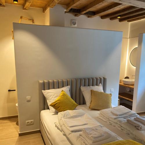a bed with two pillows at Quadratum 1769 in Herzele