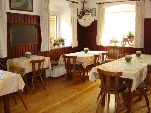 a dining room with tables and chairs and a television at Gasthof Zum heiligen Nikolaus in Haibach ob der Donau
