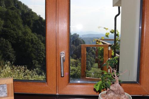 a wooden door with a view of a forest at The Lodge in Rogaška Slatina