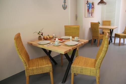 a dining room table with chairs and a table with food on it at Pension Zum Stein in Hohenkirchen