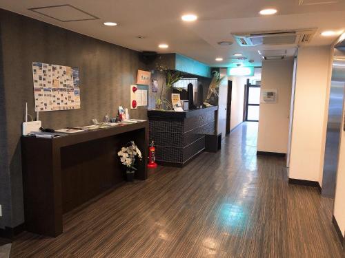 an office with a reception desk and a lobby at Business Hotel Sunpu in Shizuoka