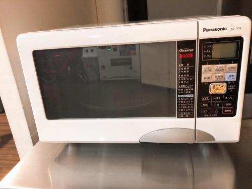 a microwave oven sitting on top of a table at Business Hotel Sunpu in Shizuoka