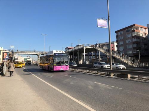 a pink bus is driving down a city street at Istanbul Fair Hotel in Istanbul