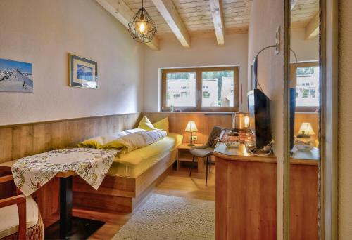 a living room with a couch and a table at Gästehaus Waltraud in Längenfeld