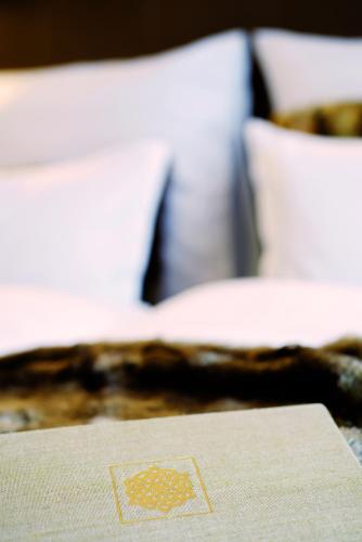 a close up of a table with a pillow on a bed at Hotel Garni Urezza in Ischgl