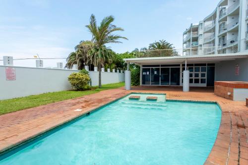 a swimming pool in the backyard of a house at 79 Chaka's Cove in Ballito