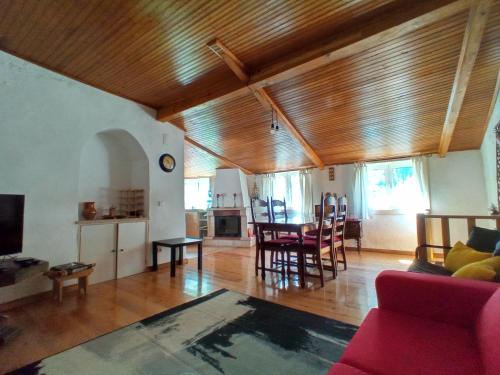 a living room with a couch and a table and chairs at Casa do Rio in Coimbra