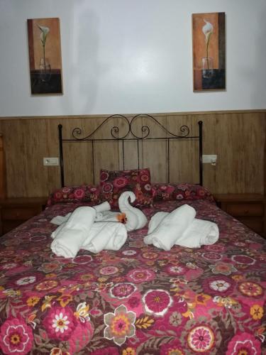 a bed with two swans made out of towels at Hostal Breñaverde in Gaucín