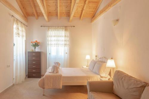 a bedroom with a bed and a couch at Emilios Stone House in Gaios