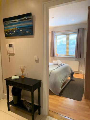 a bedroom with a bed and a table and a window at Boden Heath in Dublin