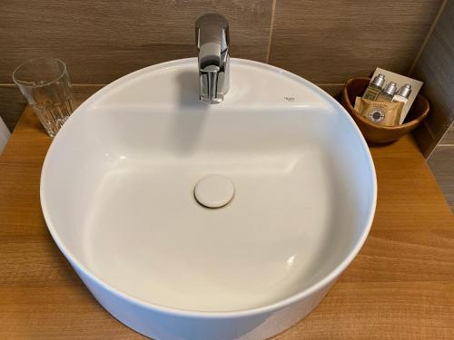 a white sink with a faucet on a counter at Apartmány Přítluky in Přítluky