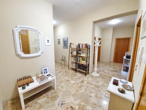 a living room with a mirror on the wall at Affittacamere Zona Caserma-Stazione in Foligno