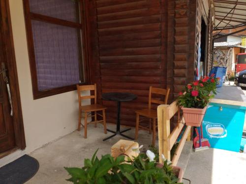 a patio with a table and chairs and a table at Apartman Milica in Kremna