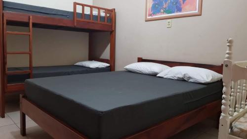 Ένα ή περισσότερα κρεβάτια σε δωμάτιο στο Casa Perequê-Açu